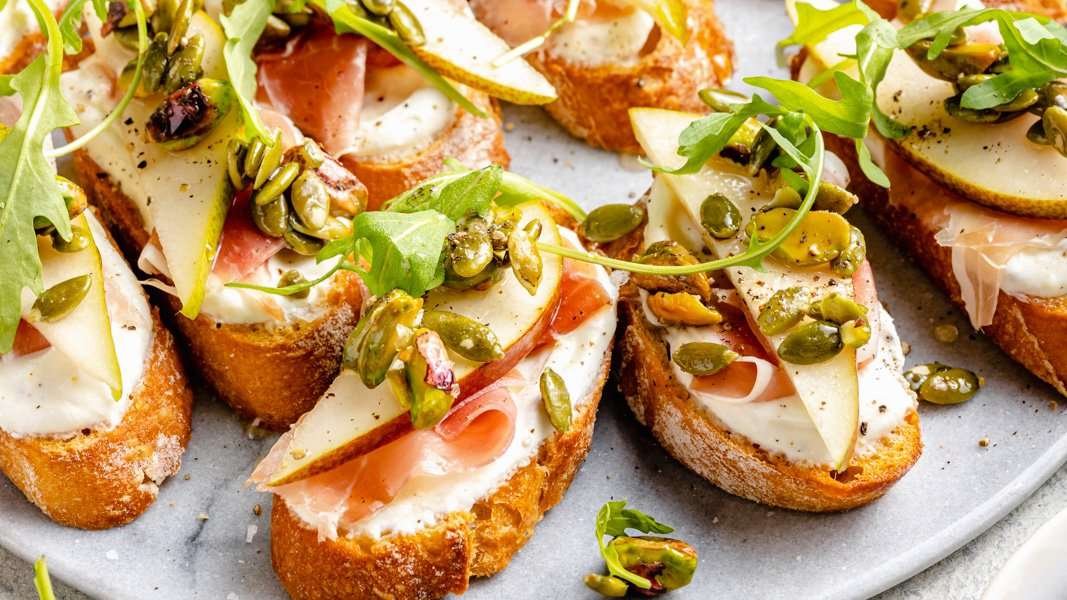 Ricotta and Pear Crostini with Salty Pumpkin Seed Pistachio Crunch
